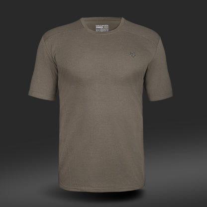 The Hillman 1UL Bamboo Short Sleeve Hunting T-shirt features an olive green palette with a subtle left chest graphic, crafted for sustainability from bamboo fiber. Its Active Vent Technology ensures breathable comfort, all set against a dark gradient backdrop.